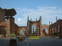 the ruins of Coventry with cross made from charred beams