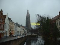 View along the Dijver towards the Church of Our Lady and Museum of Bruges (Onthaalkerk Onze Lieve Vrouw en Bruggemueum) Bruges Belgium copyright free photo royalty free photo January 2007